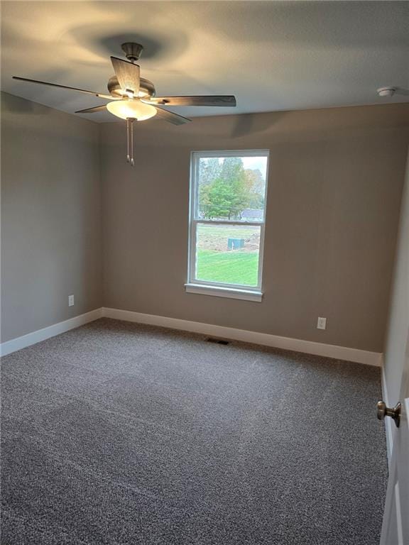 empty room with ceiling fan and carpet