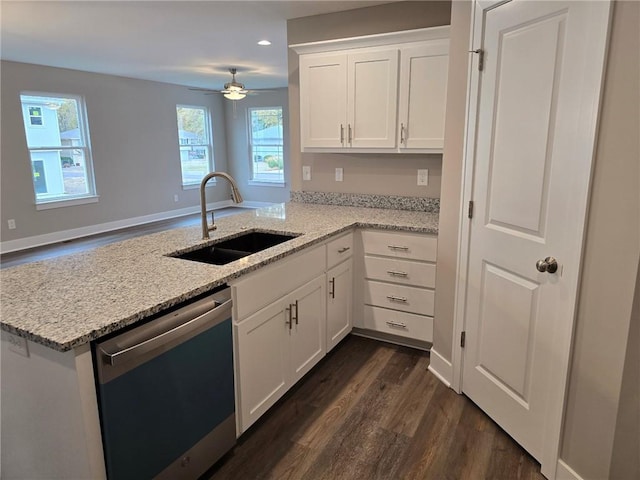 kitchen featuring dark hardwood / wood-style flooring, sink, white cabinets, stainless steel dishwasher, and kitchen peninsula