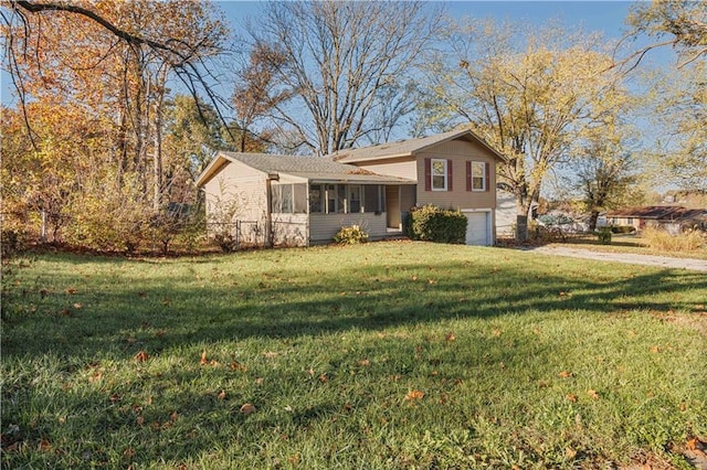 tri-level home with a garage and a front yard