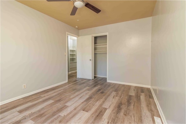 unfurnished bedroom featuring light hardwood / wood-style floors, ceiling fan, and a closet