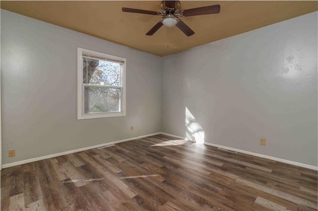 unfurnished room with dark hardwood / wood-style floors and ceiling fan