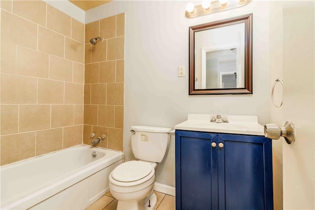 full bathroom featuring vanity, tile patterned floors, toilet, and tiled shower / bath combo