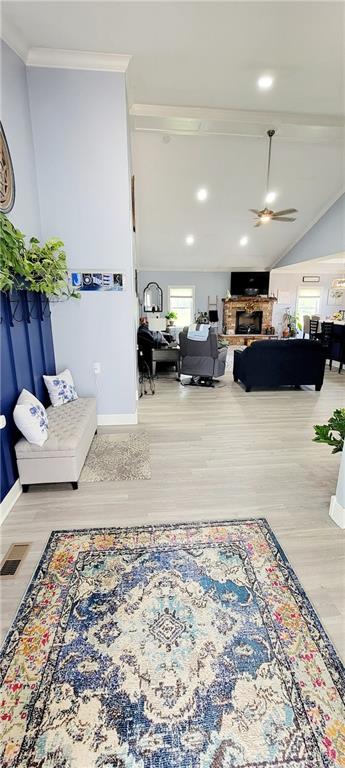 interior space with ornamental molding, hardwood / wood-style floors, and ceiling fan