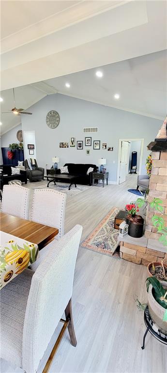 dining room featuring vaulted ceiling, hardwood / wood-style flooring, and ceiling fan