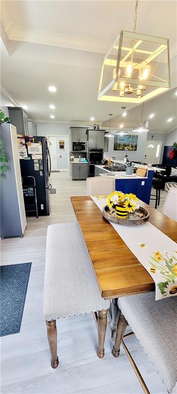 dining area featuring light hardwood / wood-style floors and a chandelier