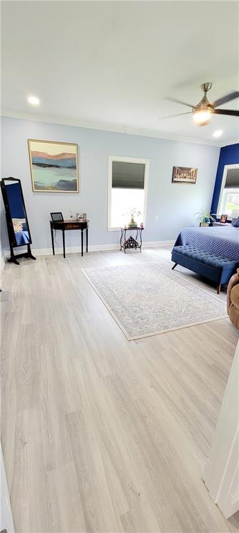 bedroom with light hardwood / wood-style floors and ceiling fan