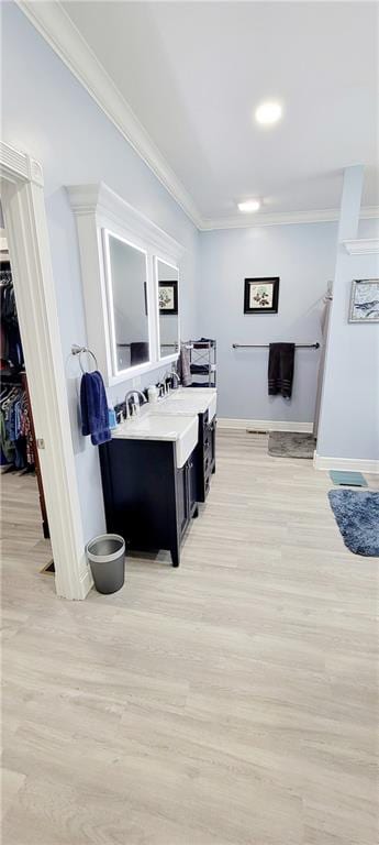 hallway featuring light wood-type flooring and ornamental molding