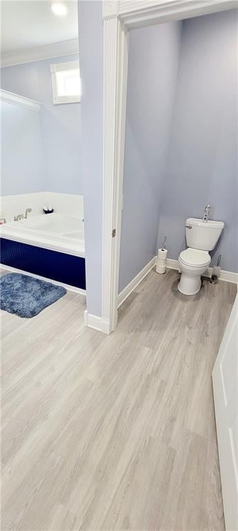 bathroom with wood-type flooring, a skylight, and toilet