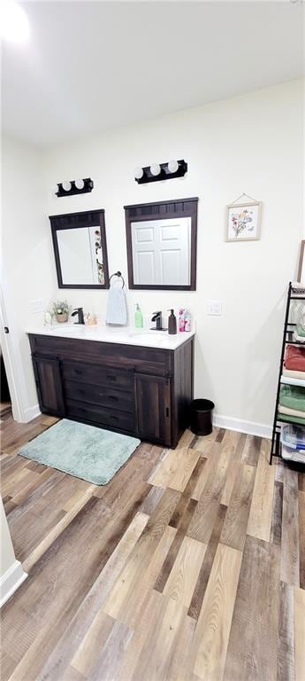 bathroom with vanity and hardwood / wood-style flooring