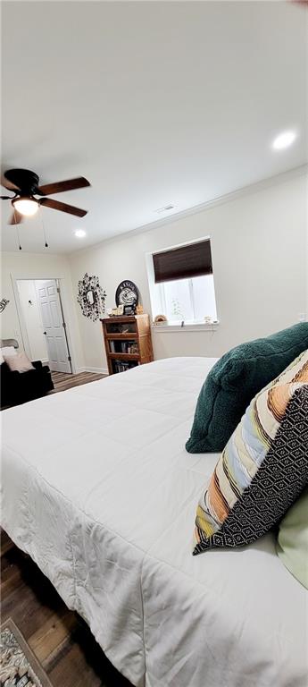 bedroom featuring hardwood / wood-style flooring and ceiling fan