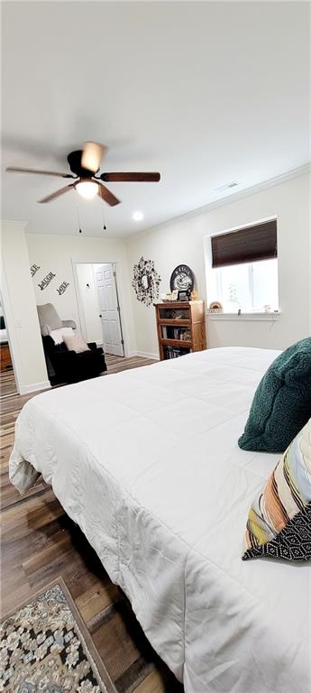 bedroom featuring dark hardwood / wood-style flooring and ceiling fan