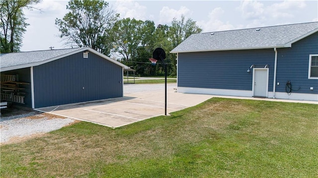 back of property featuring basketball court and a yard