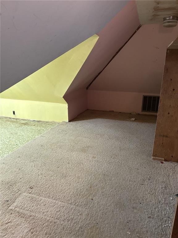 additional living space featuring lofted ceiling and carpet floors