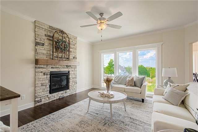 living room with a fireplace, dark hardwood / wood-style floors, ceiling fan, and crown molding