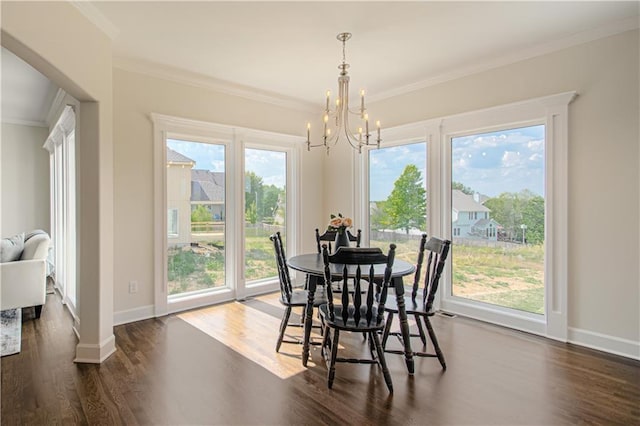 dining space featuring crown molding, dark wood-type flooring, and an inviting chandelier