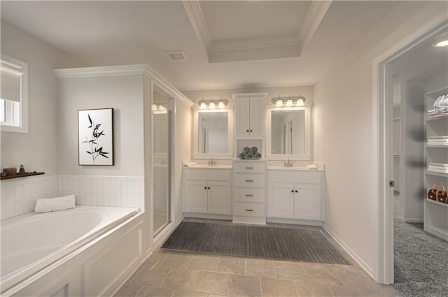 bathroom with shower with separate bathtub, vanity, a raised ceiling, and crown molding