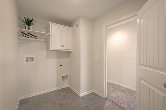 clothes washing area with cabinets, hookup for a washing machine, dark tile patterned flooring, and electric dryer hookup