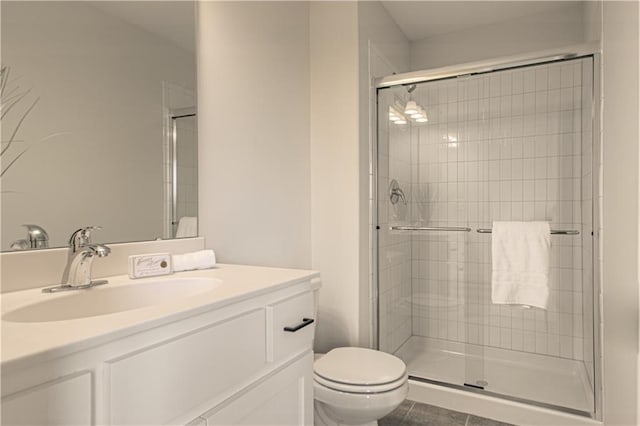 bathroom with tile patterned floors, toilet, and a shower with shower door