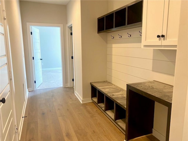 mudroom featuring baseboards and light wood-style floors