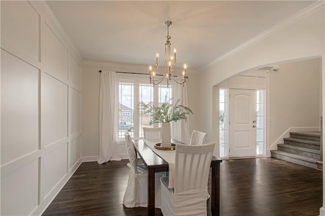 dining area with stairway, crown molding, a chandelier, arched walkways, and dark wood-style flooring