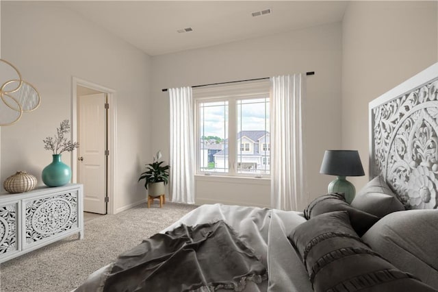 carpeted bedroom featuring baseboards and visible vents