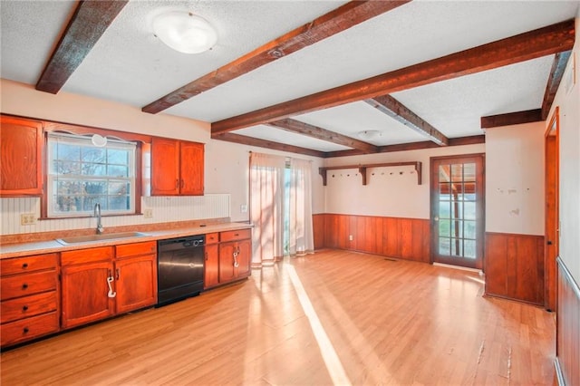 kitchen with beam ceiling, sink, light wood-type flooring, and dishwasher