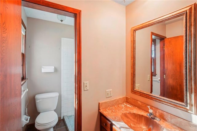 bathroom featuring vanity, tile patterned flooring, and toilet