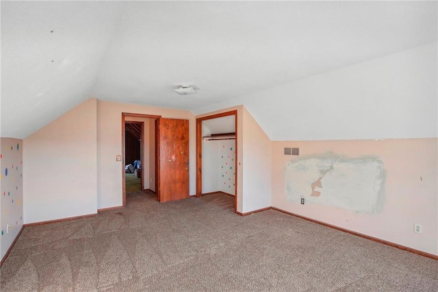 bonus room featuring lofted ceiling and carpet