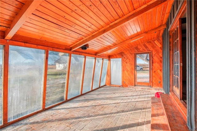 unfurnished sunroom with lofted ceiling with beams and wood ceiling