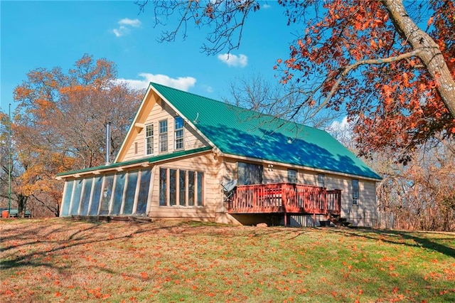 rear view of property featuring a yard and a deck