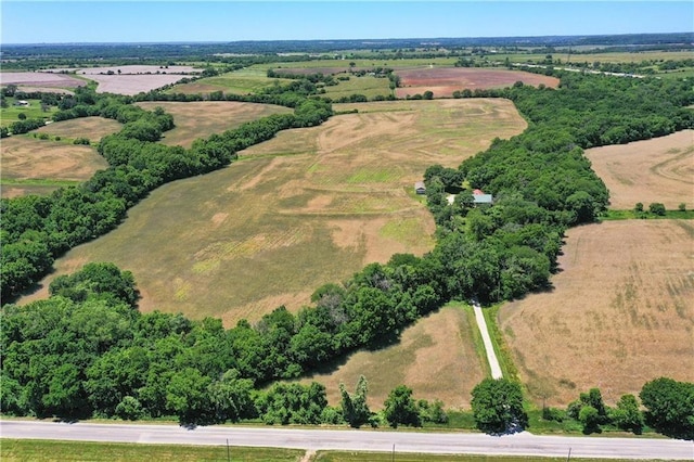 birds eye view of property with a rural view