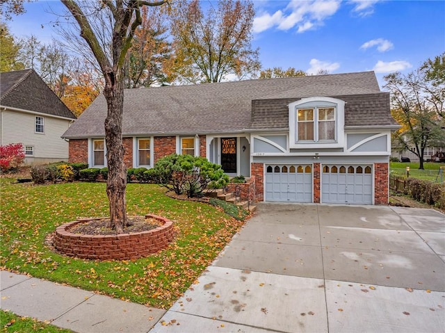 view of front of house featuring a garage and a front lawn