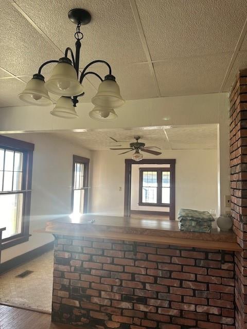 interior space with wood-type flooring, a textured ceiling, and a wealth of natural light