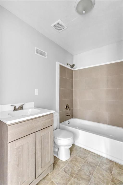 9043 Walnut St, Kansas City, MO 64114 - bathroom with toilet, shower / washtub combination, and vanity