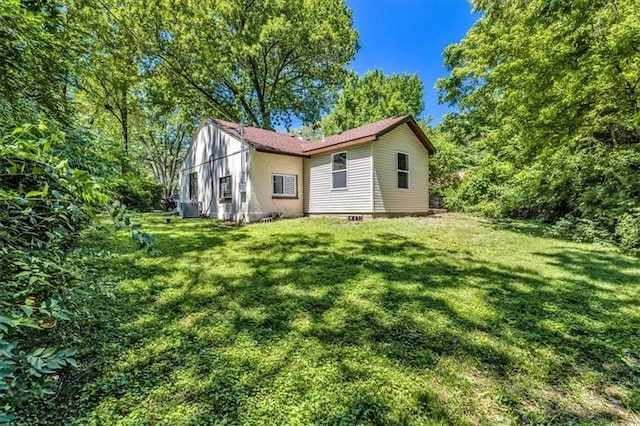 9043 Walnut St, Kansas City, MO 64114 - rear view of property with cooling unit and a yard