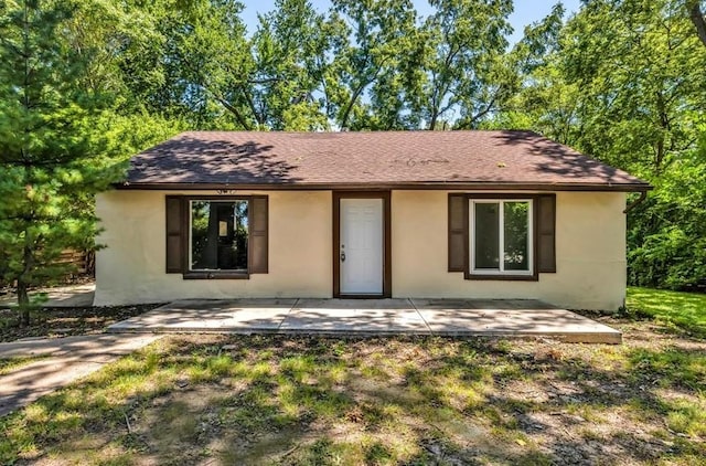 9043 Walnut St, Kansas City, MO 64114 - view of front of home featuring a patio, stucco siding, and a shingled roof