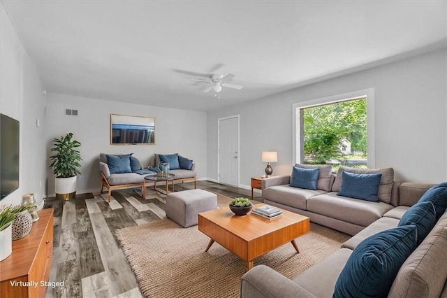 9043 Walnut St, Kansas City, MO 64114 - living room with wood finished floors, a ceiling fan, and baseboards