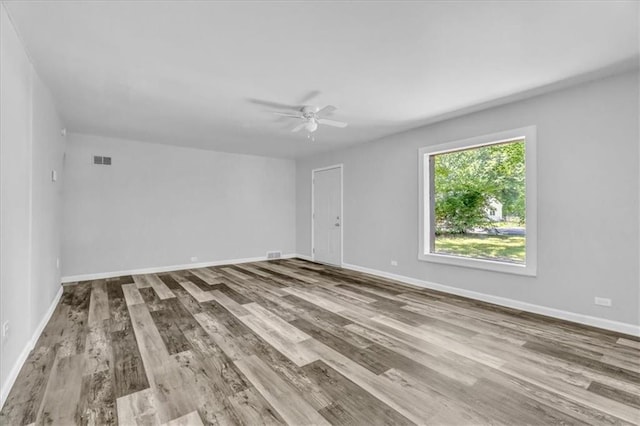 9043 Walnut St, Kansas City, MO 64114 - empty room featuring wood finished floors, ceiling fan, and baseboards