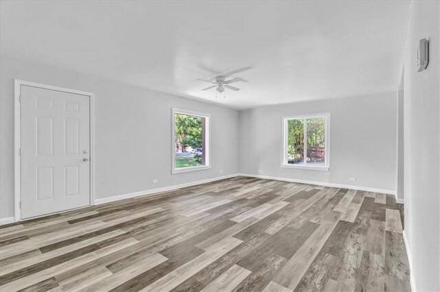 9043 Walnut St, Kansas City, MO 64114 - spare room featuring a ceiling fan, wood finished floors, and baseboards