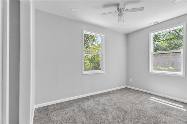 9043 Walnut St, Kansas City, MO 64114 - carpeted spare room with baseboards and a ceiling fan