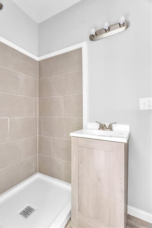 9043 Walnut St, Kansas City, MO 64114 - bathroom featuring a stall shower, vanity, and baseboards