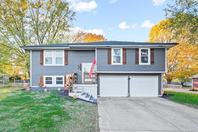 split foyer home with a front yard and a garage