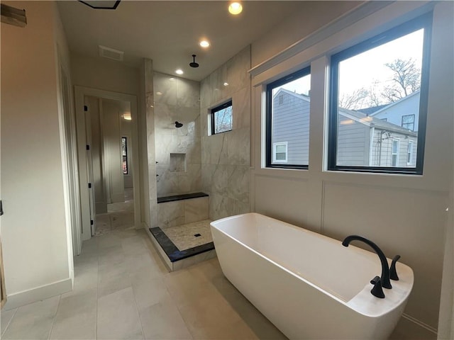 bathroom with separate shower and tub and tile patterned floors