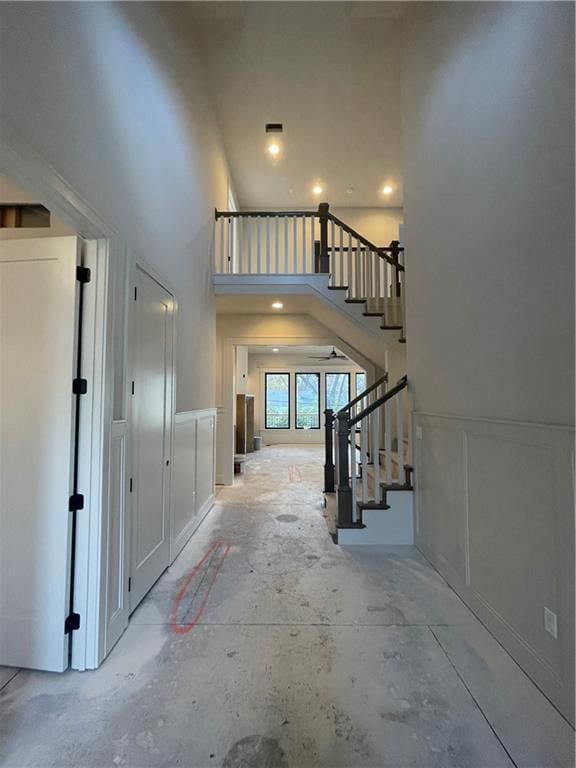 entrance foyer featuring high vaulted ceiling