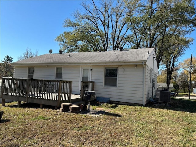 back of property with cooling unit, a yard, and a wooden deck