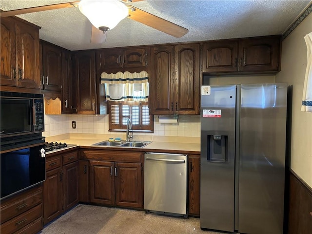 kitchen with sink, a textured ceiling, ceiling fan, backsplash, and black appliances