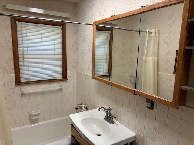 bathroom with shower / bathtub combination with curtain and vanity