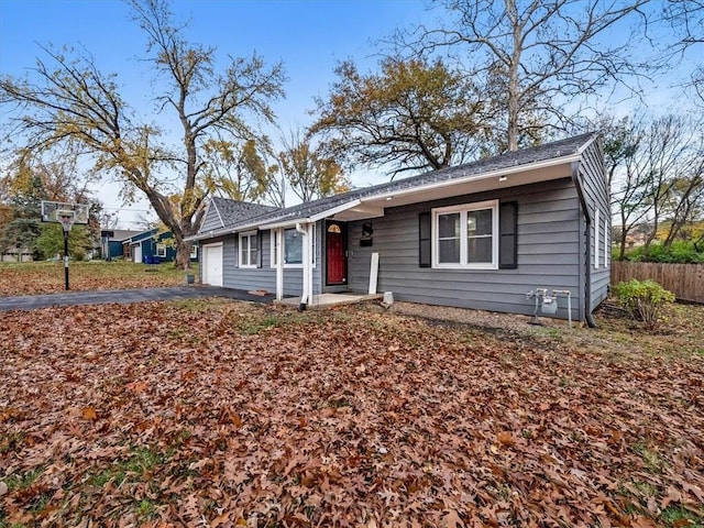 9317 Gillette St, Lenexa, KS 66215 - view of front of property featuring an attached garage, asphalt driveway, and a shingled roof