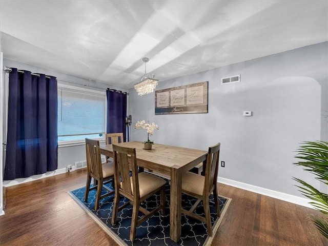 9317 Gillette St, Lenexa, KS 66215 - dining room with dark wood finished floors and a chandelier