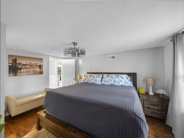 9317 Gillette St, Lenexa, KS 66215 - bedroom with a textured ceiling, wood finished floors, and a chandelier